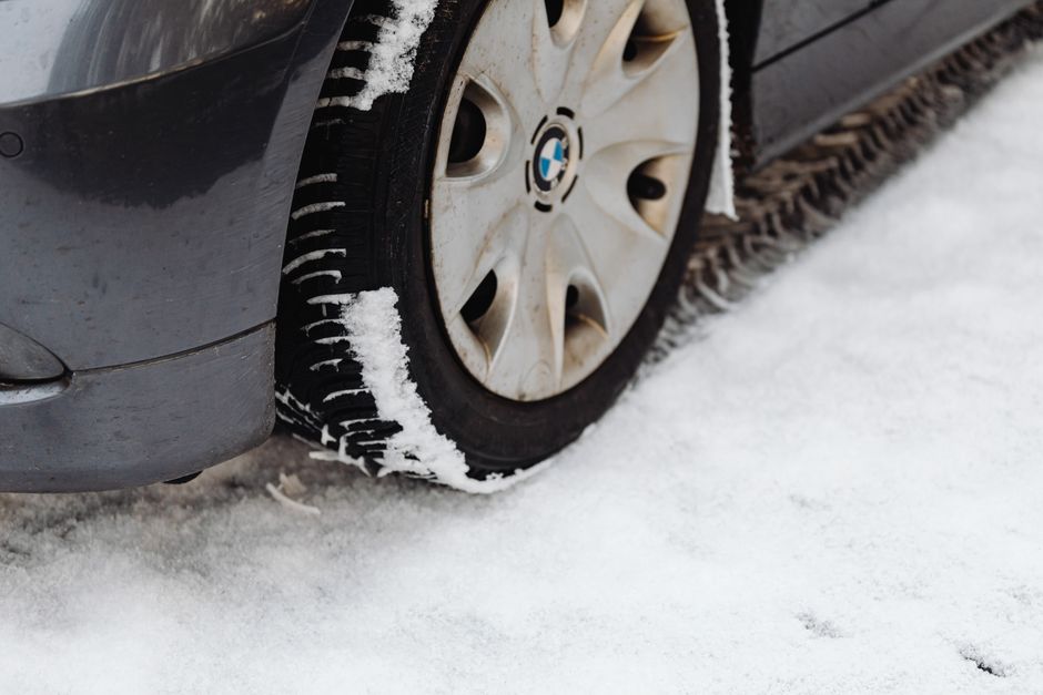 Technician checking tire tread depth and condition